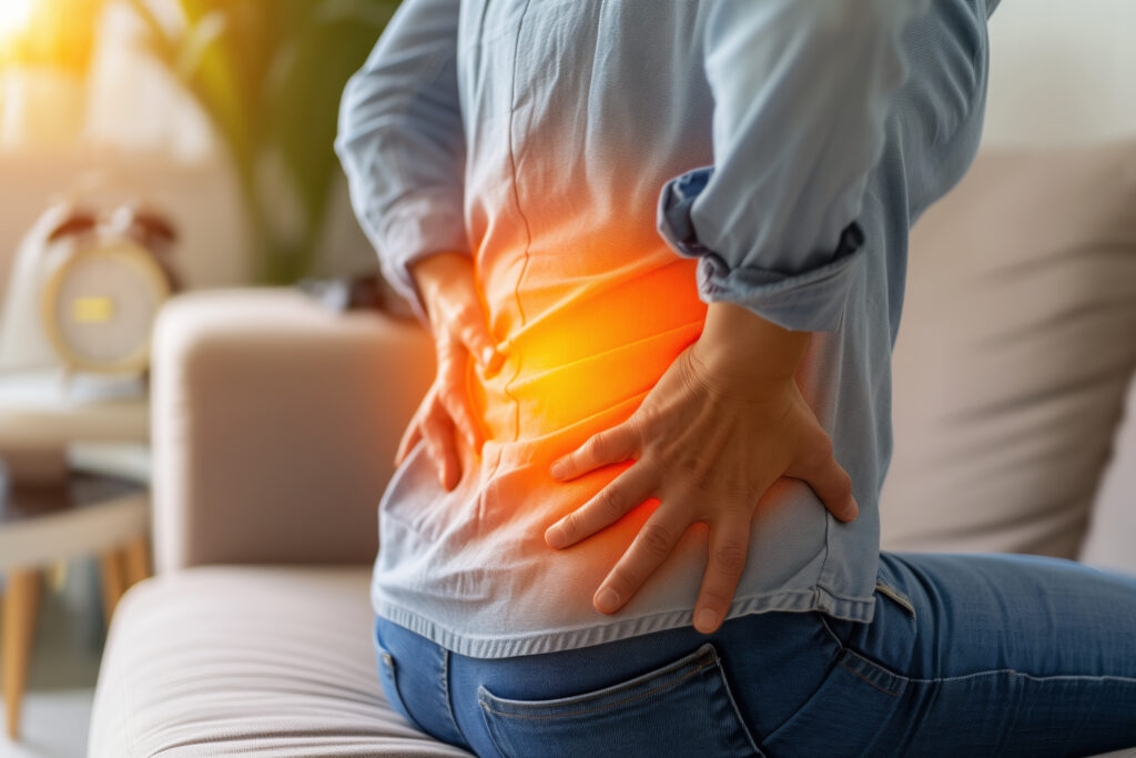 Picture of patient experiencing lower back pain as a result of a kidney stone.